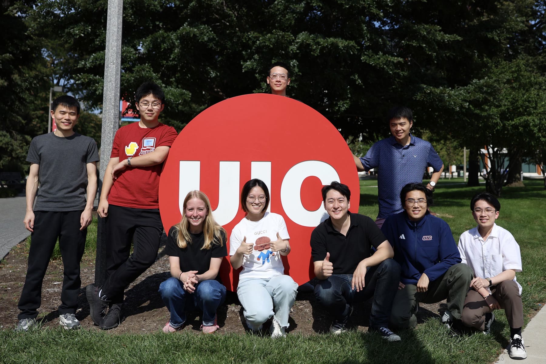 Adaptive Robotics Lab members gathered at the UIC campus sign